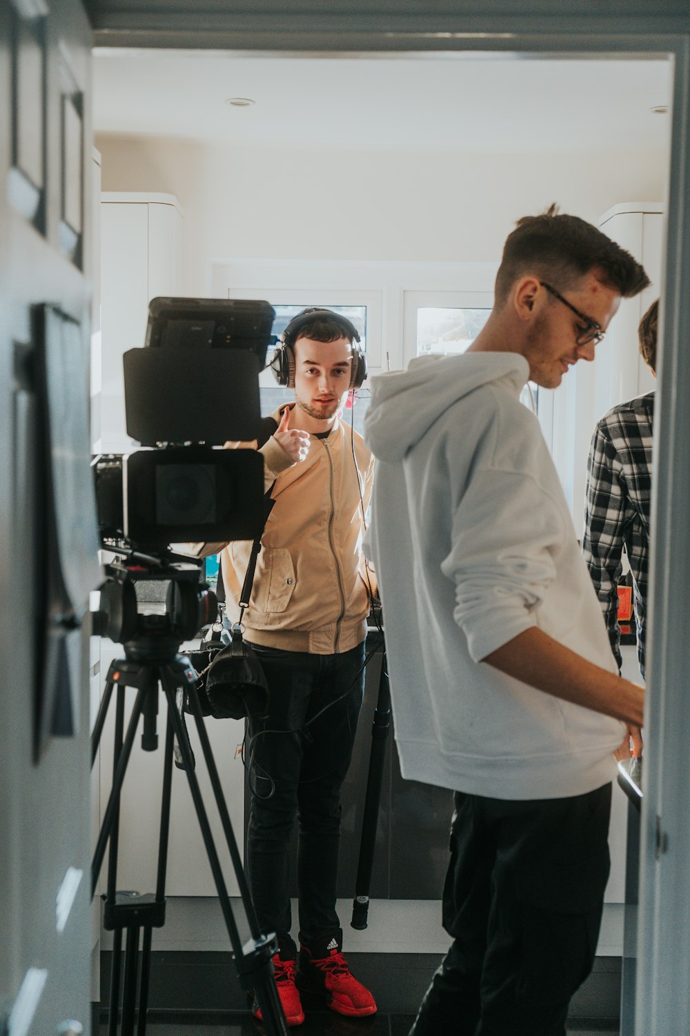 a man standing in front of a camera next to a woman