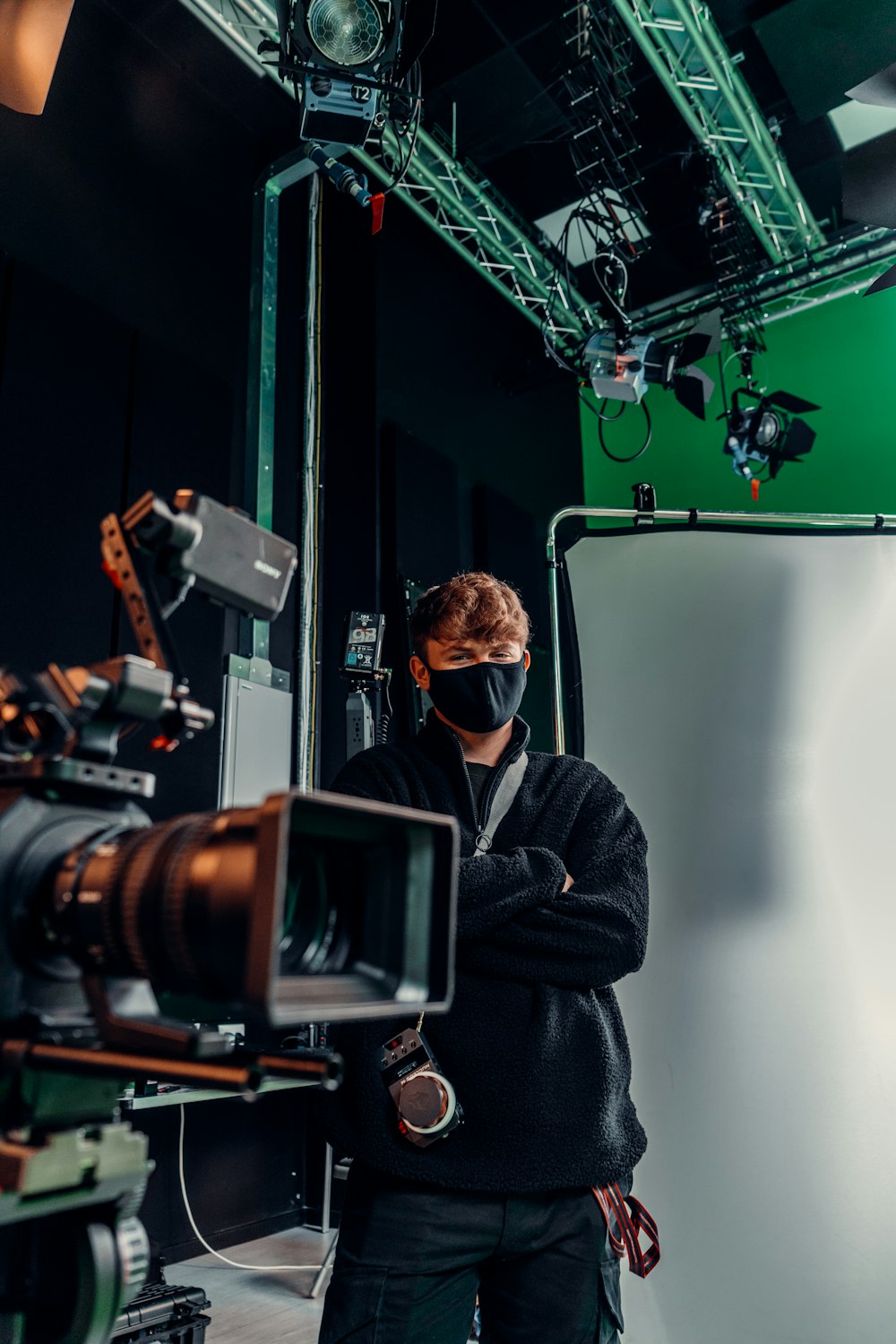 a man in a black jacket and a camera