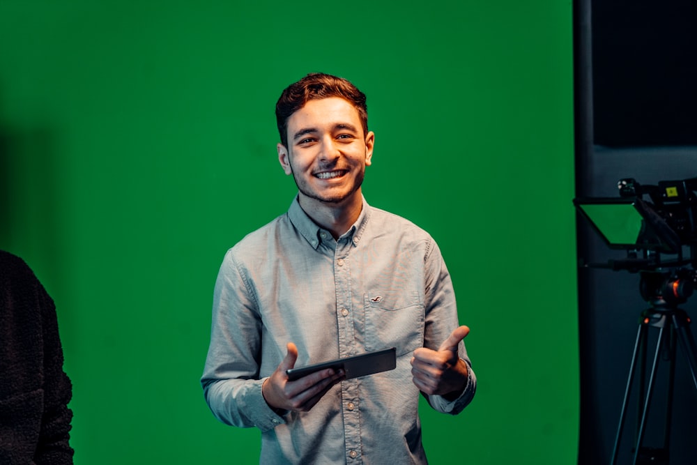 a man standing in front of a green screen