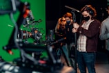 a group of people standing around a camera