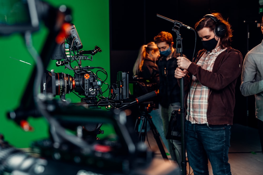 a group of people standing around a camera