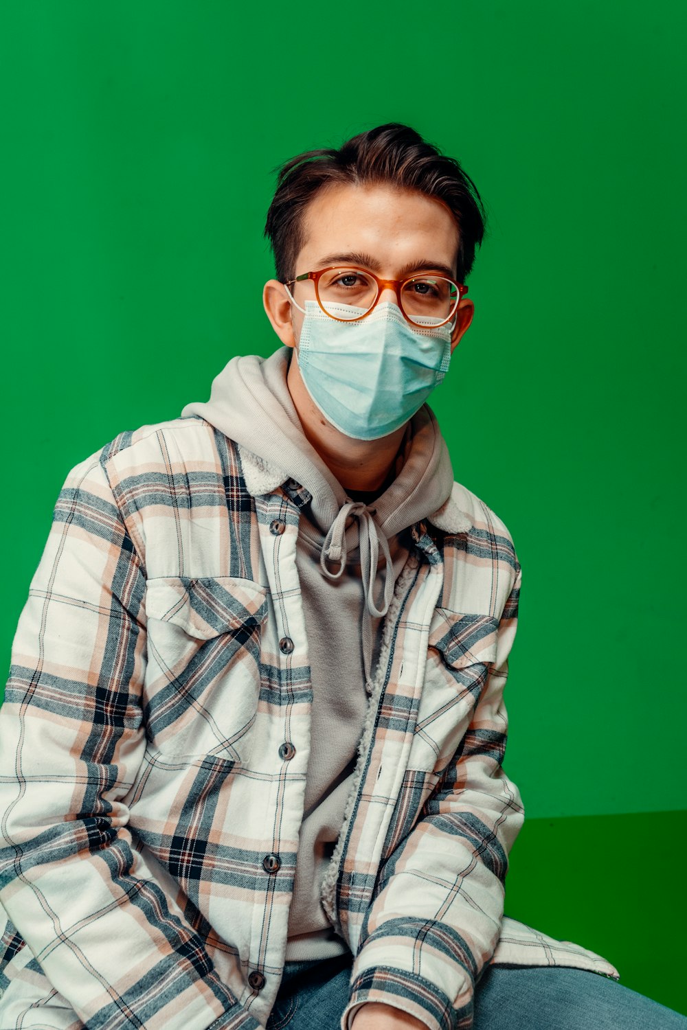 a man wearing a face mask sitting down