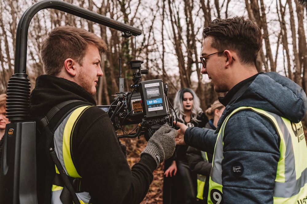 a group of people standing around a camera