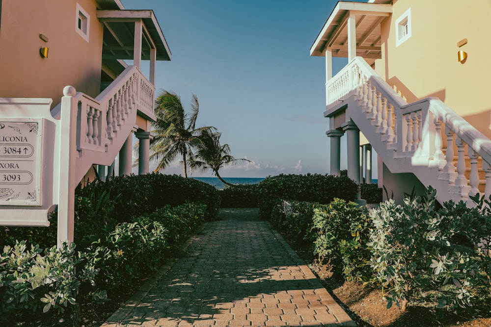 a walkway leading to a beach side resort
