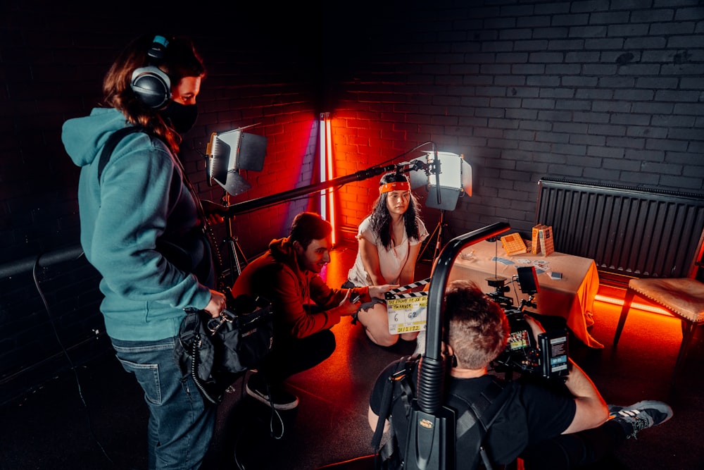 a group of people sitting around a recording studio