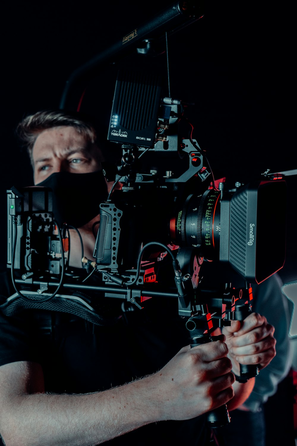 a man in a black shirt is holding a camera