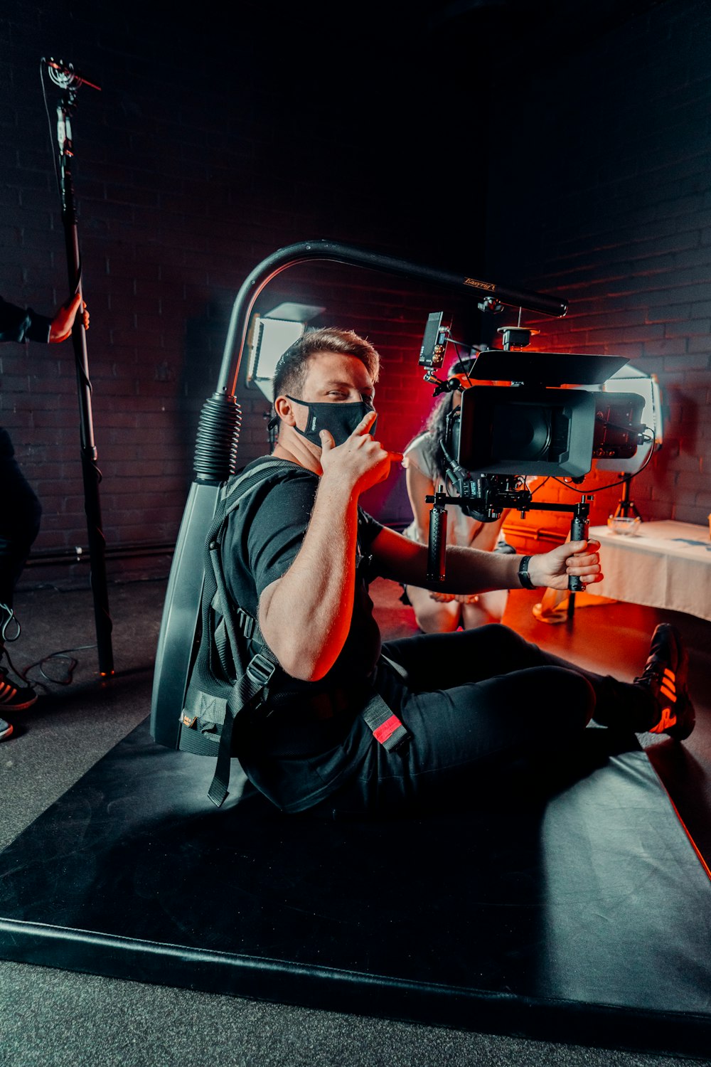 a man in a black shirt is sitting on a black mat