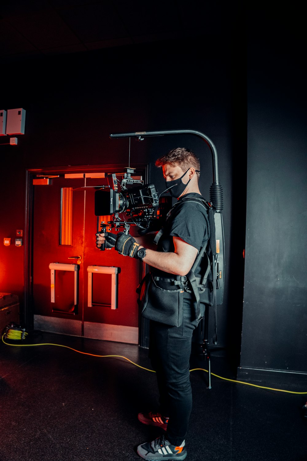 a man standing in front of a camera in a dark room