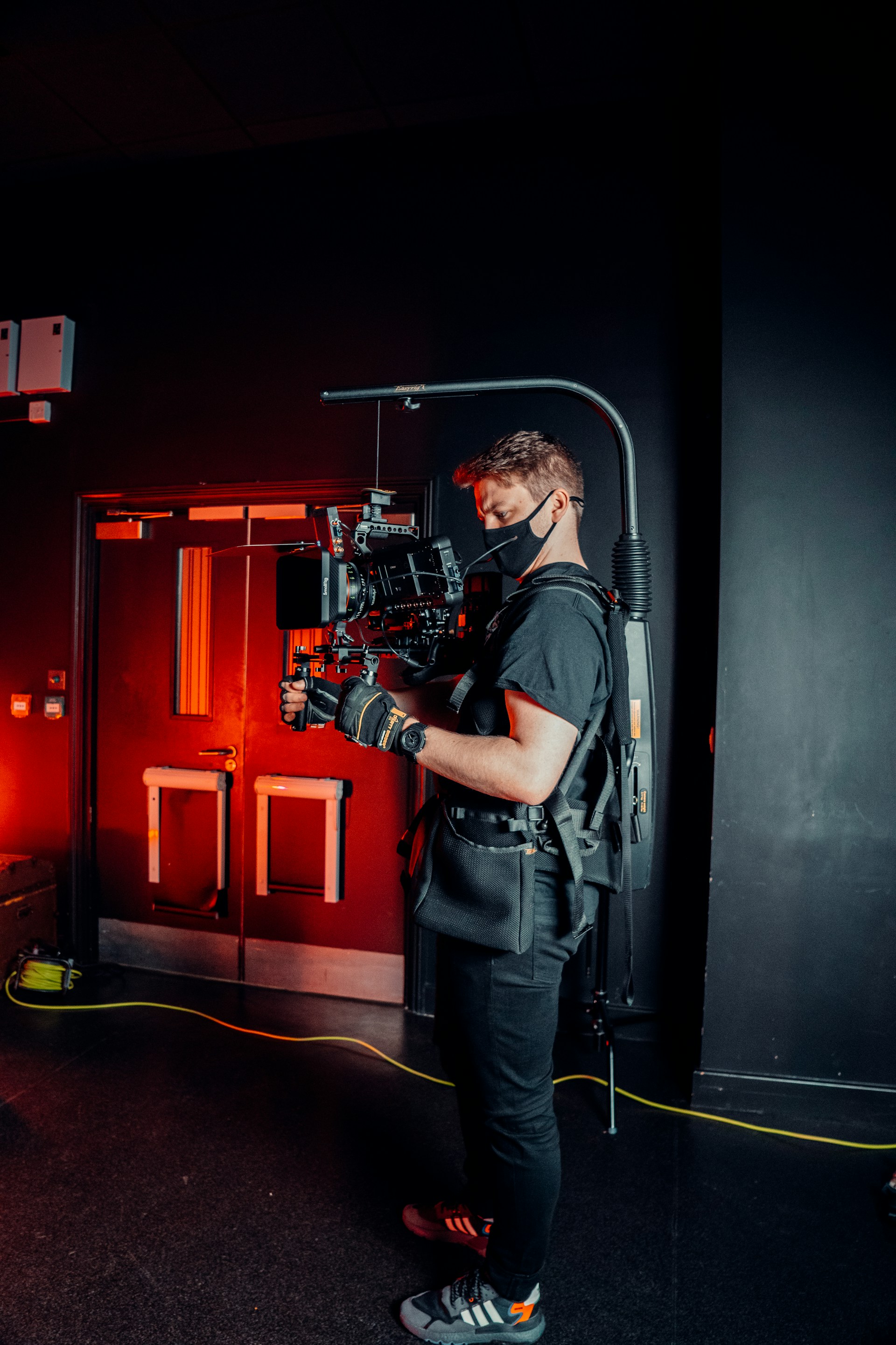 a man standing in front of a camera in a dark room