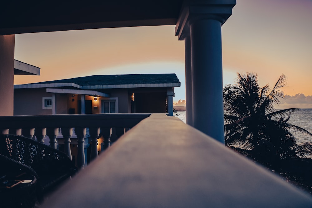 a view of the ocean from a balcony at sunset