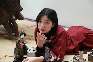 A researcher analyzing data with cultural artifacts surrounding them.