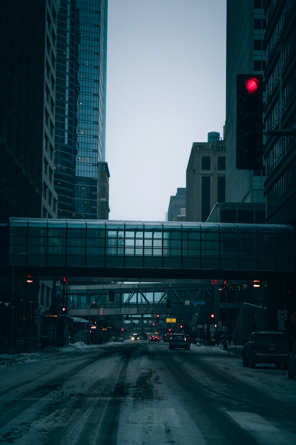 a red traffic light hanging over a city street