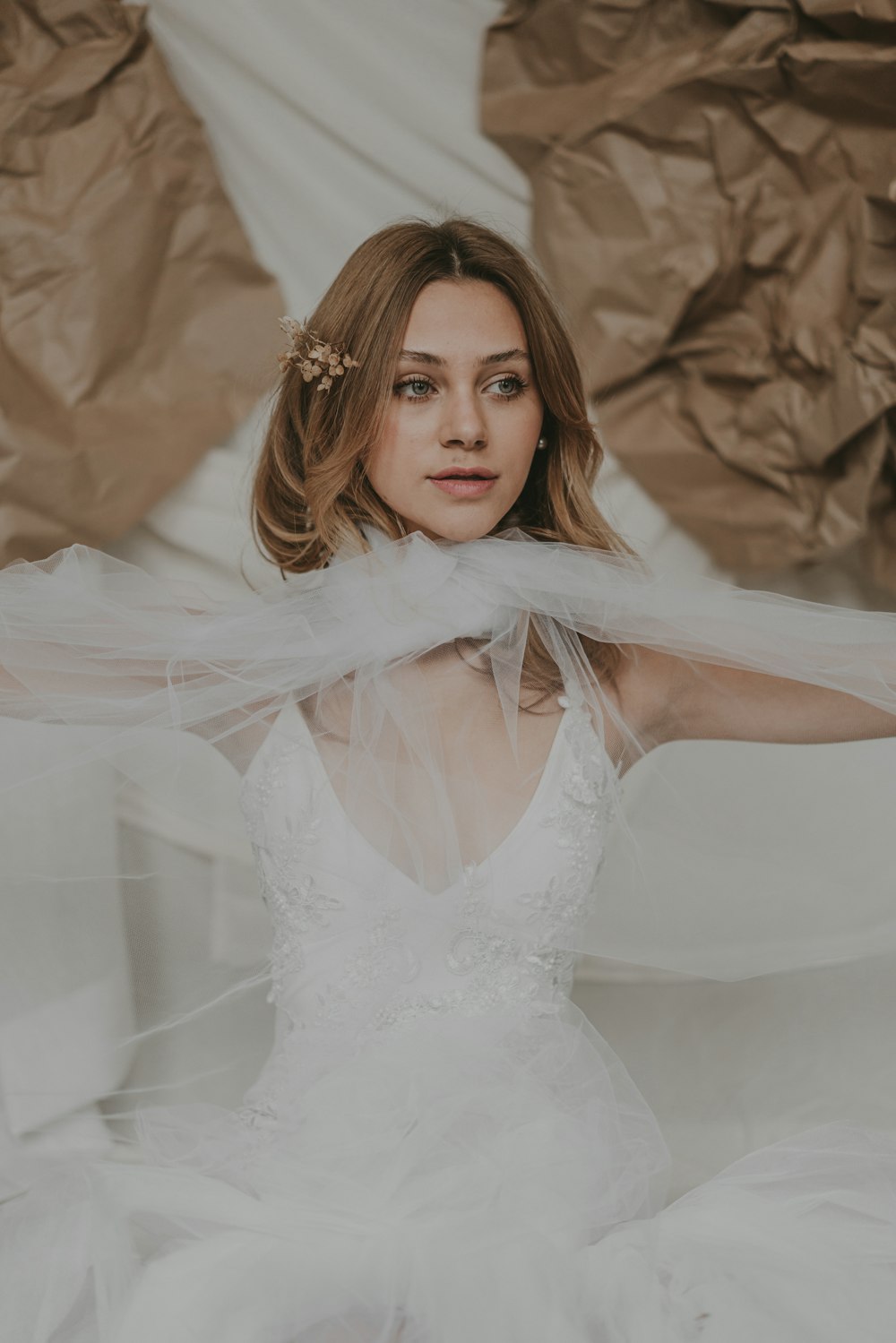 a woman in a white dress with a veil over her head