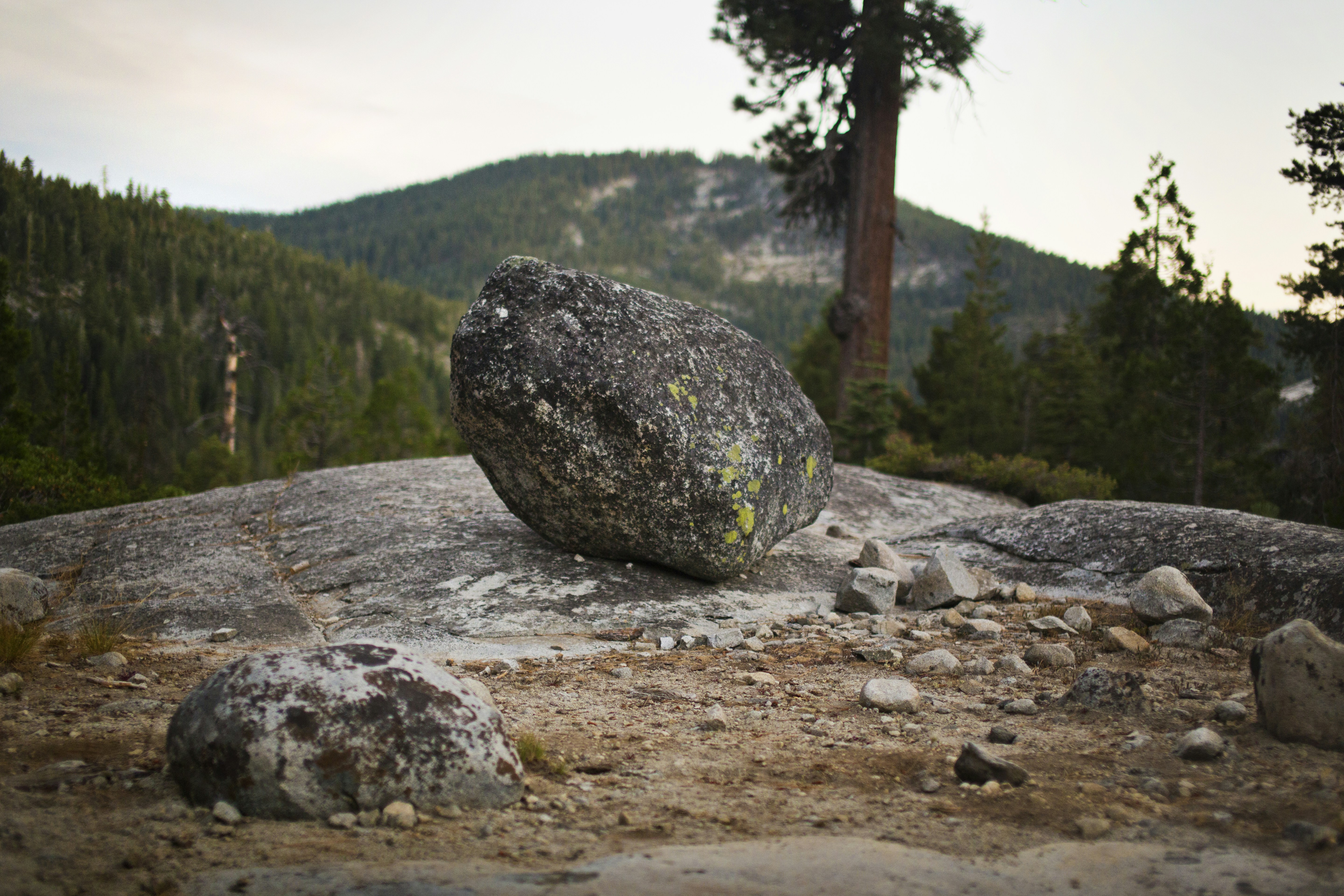 a large rock sitting on top of a rocky hillside