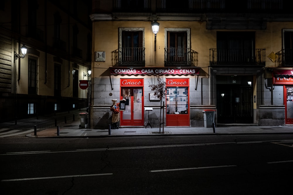 a street corner with a store front at night