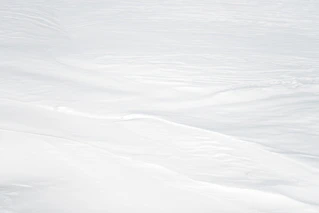a man riding skis down a snow covered slope