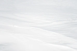 a man riding skis down a snow covered slope