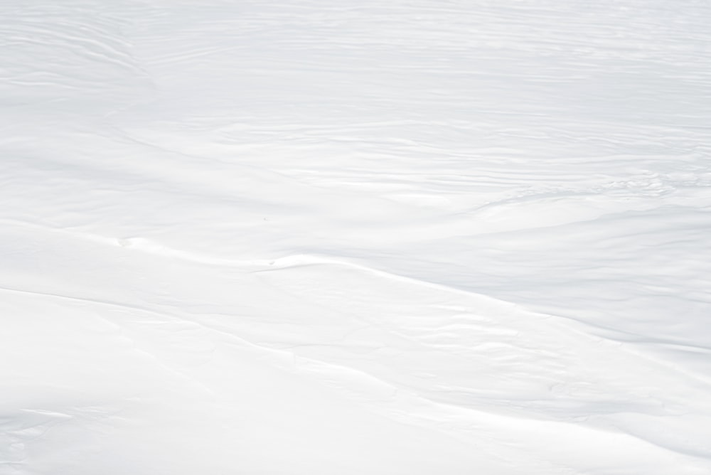 a man riding skis down a snow covered slope