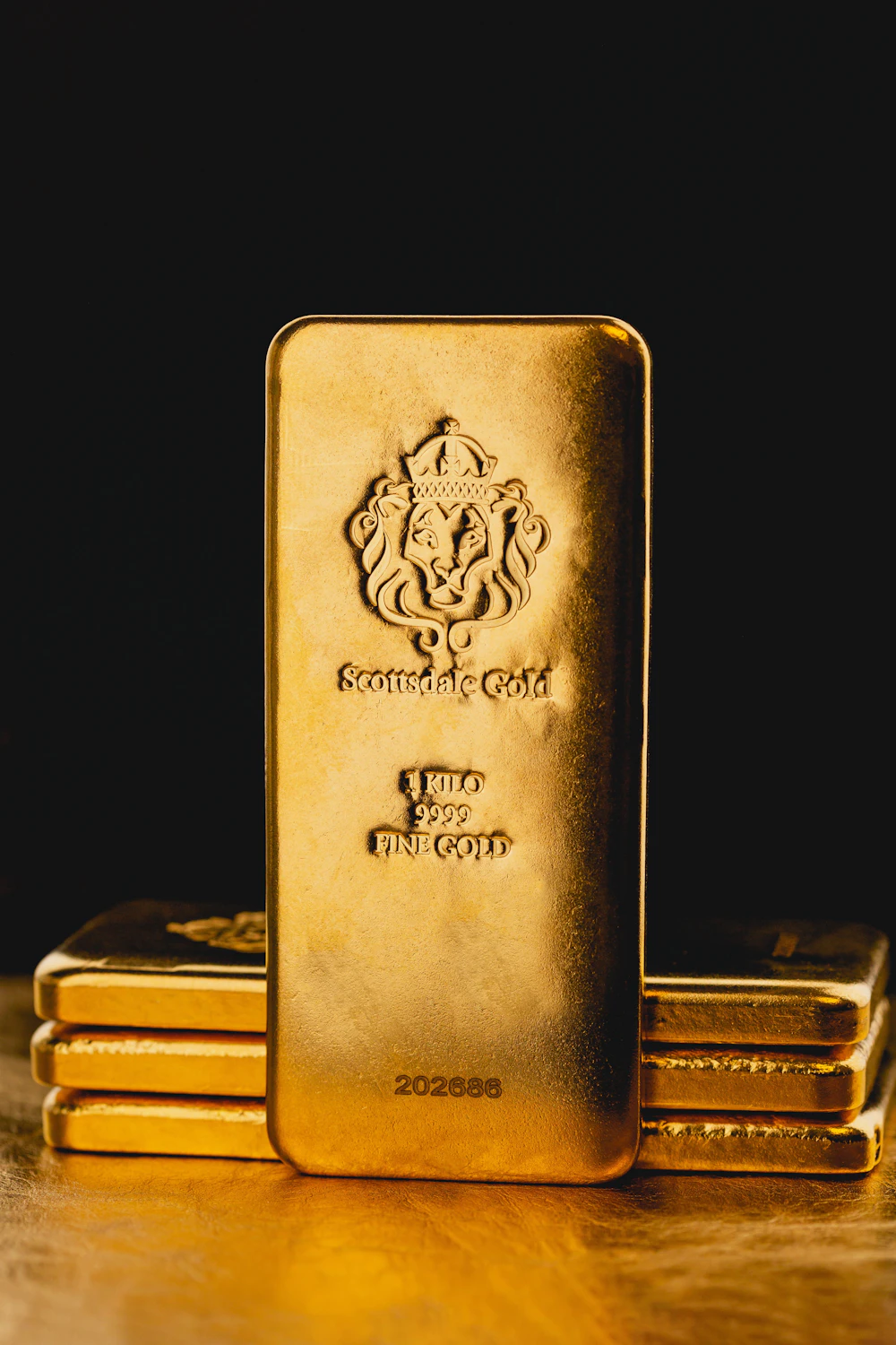 One kilogram gold bullion bars on a dark background