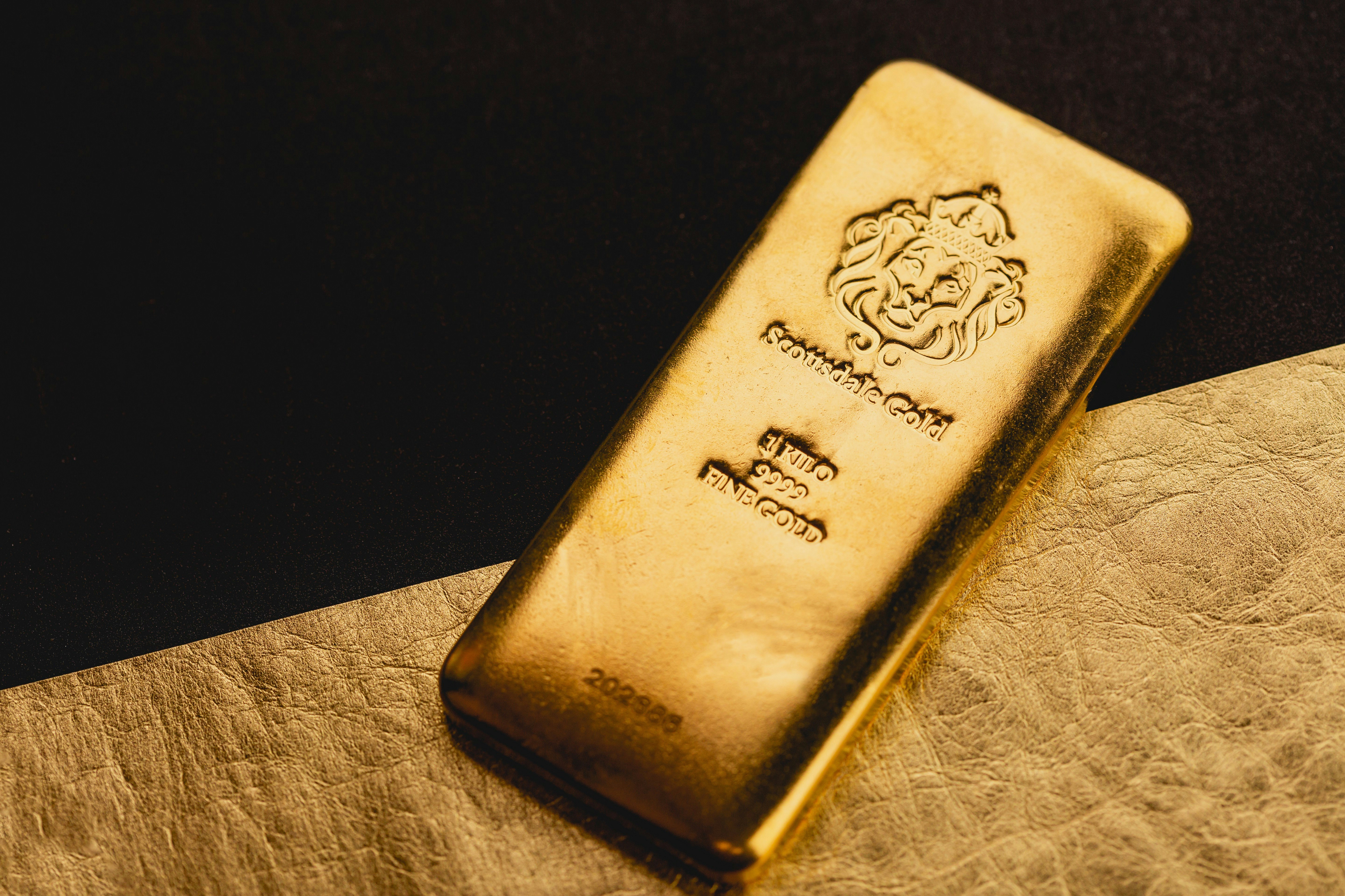Beautiful 1 Kilogram Gold Bullion Bars by Scottsdale Mint sitting on a dark background. Please give a shoutout to Scottsdale Mint if able! Shop online for the most beautiful bullion at ScottsdaleMint.com!