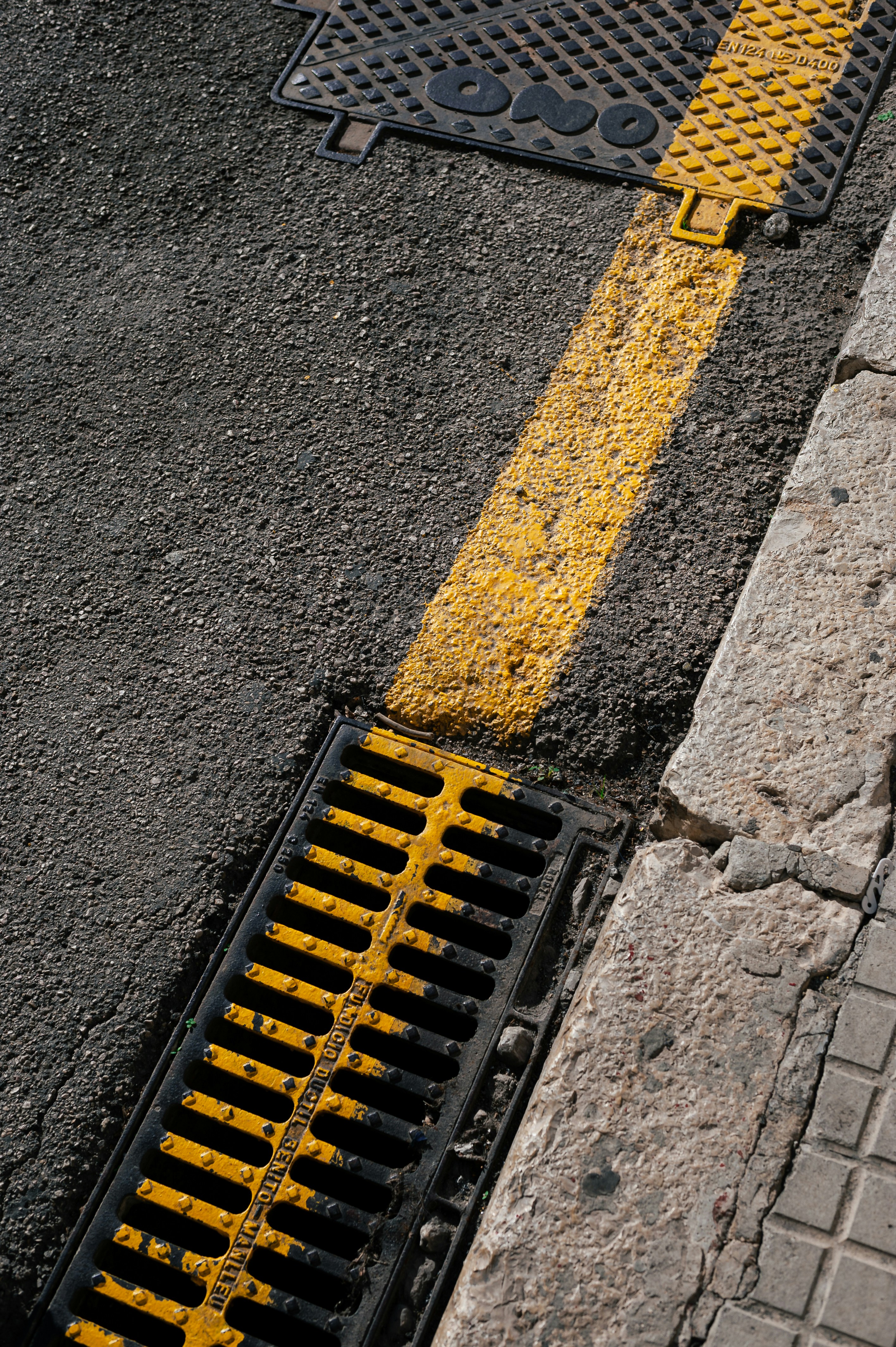 a yellow and black grate laying on the ground