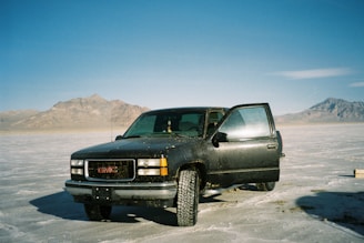 Ram 1500 GMC rugged and ready, with mountain peaks in the background.