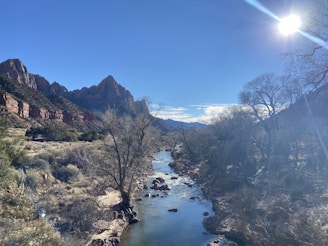 A serene landscape featuring twin canyons under a clear blue sky.