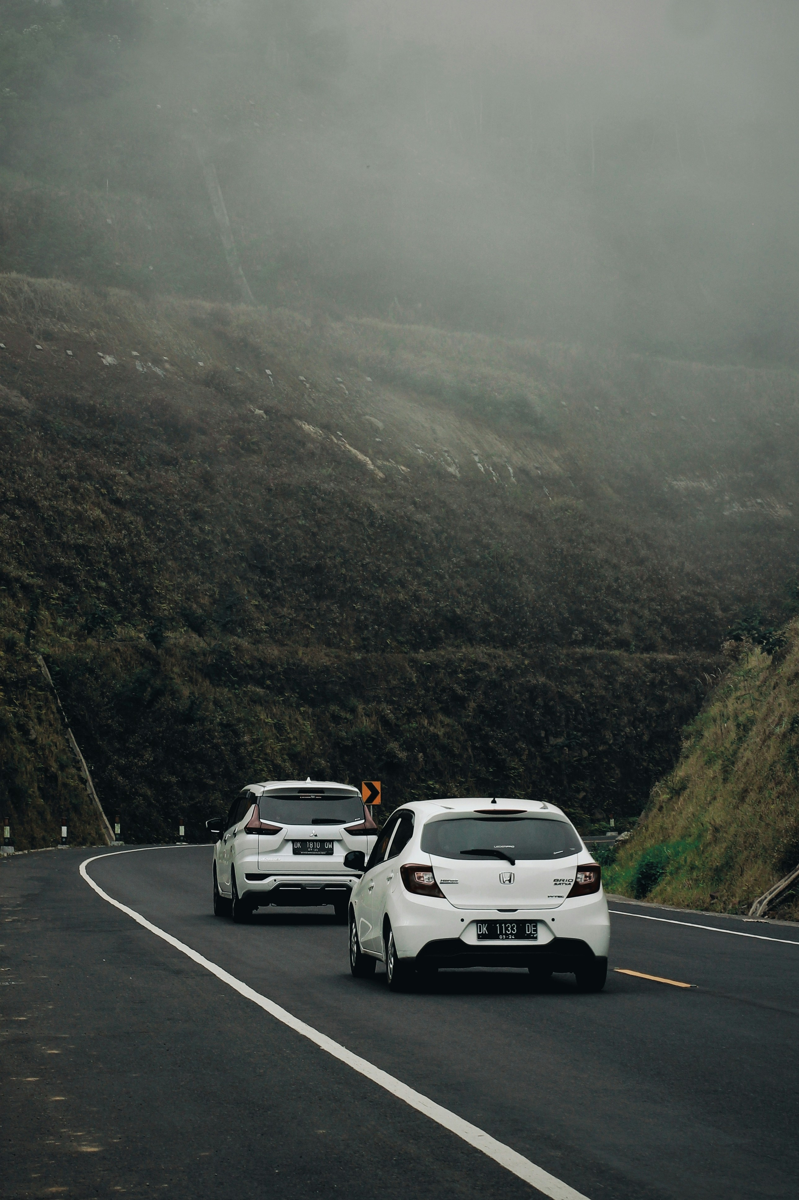 a couple of cars that are sitting in the street
