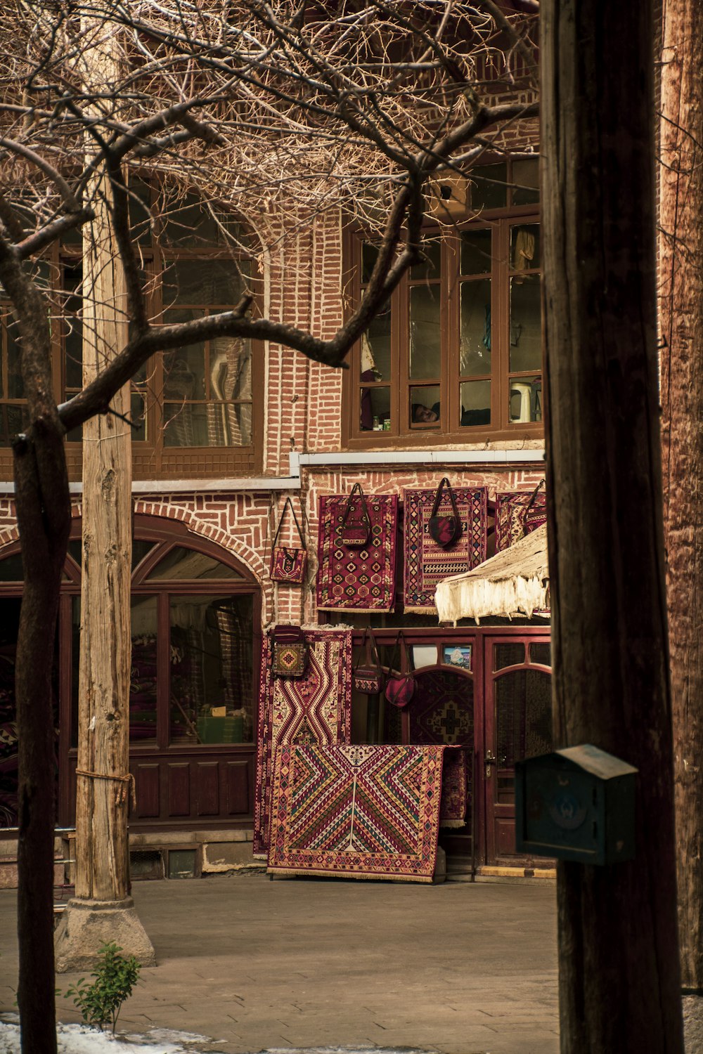 a building with a bunch of rugs on the outside of it