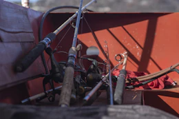 a bunch of fishing rods are in the back of a boat
