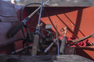 a bunch of fishing rods are in the back of a boat