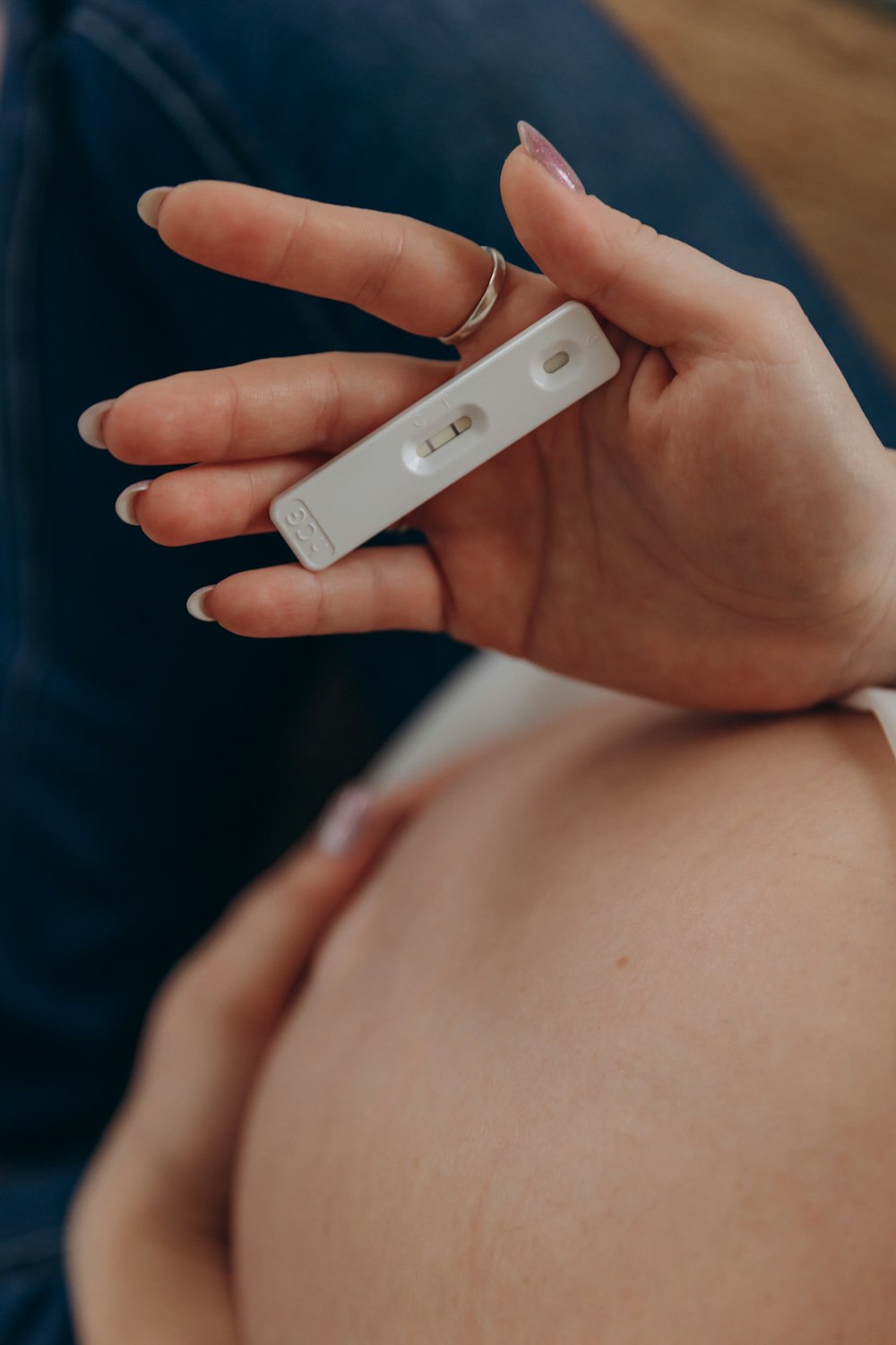 a hand holding a video game remote control