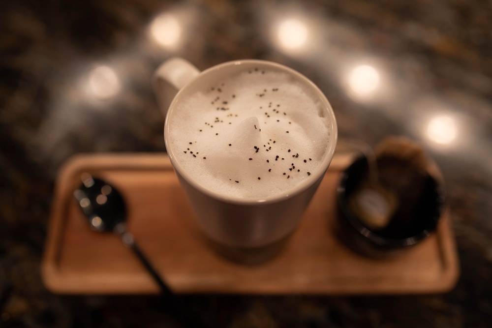 a cup of coffee with a spoon on a tray