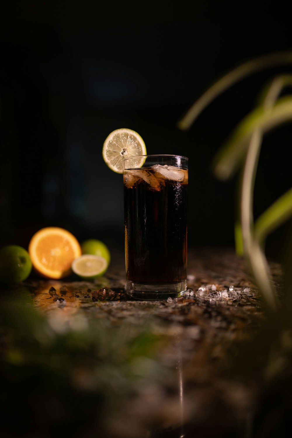 a glass of soda with a slice of lemon on the side