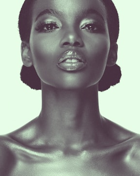 a woman with black hair and a silver make - up