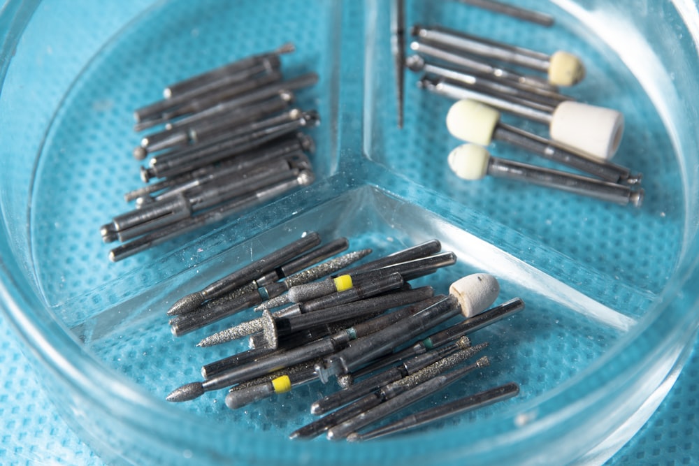 a bunch of small toothbrushes in a clear container
