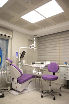 A warm dental clinic room with calming blue and purple tones reflecting the #3f3d73 palette.