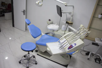 a dental room with a blue chair and dental equipment