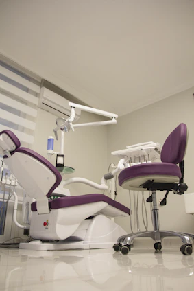 Modern dental clinic interior with clean white and navy blue design accented by golden details.