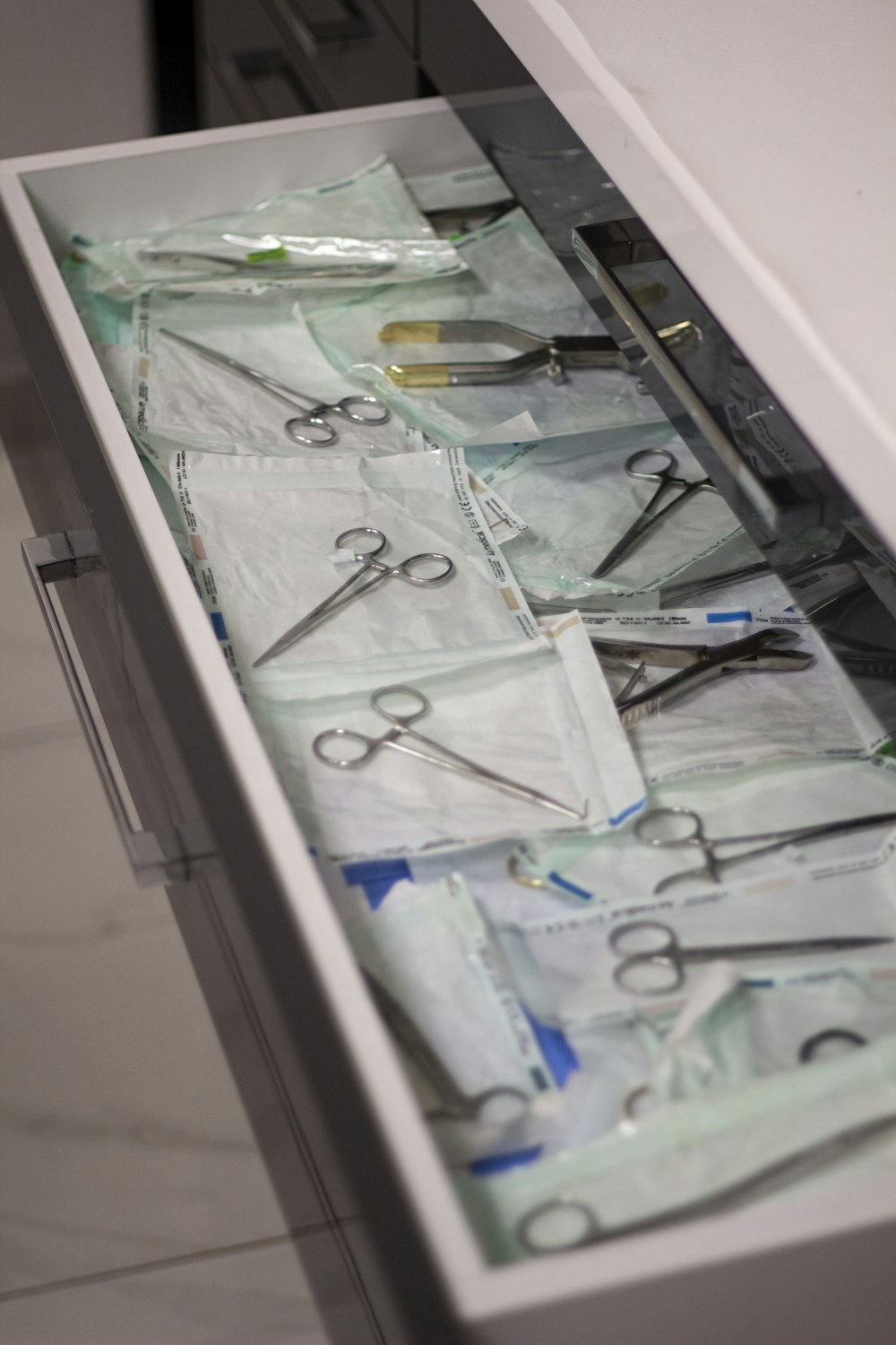 a drawer with scissors and other medical supplies