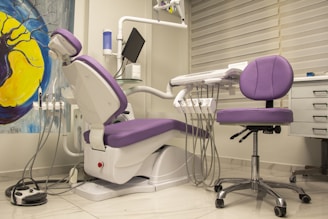 a purple and white dental chair in a room