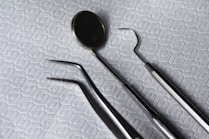 a pair of dental instruments sitting on top of a bed