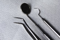 a pair of dental instruments sitting on top of a bed