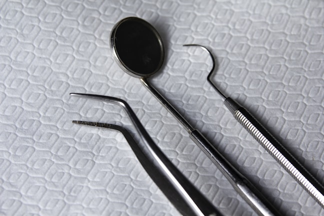 A close-up of dental tools arranged neatly on a table.