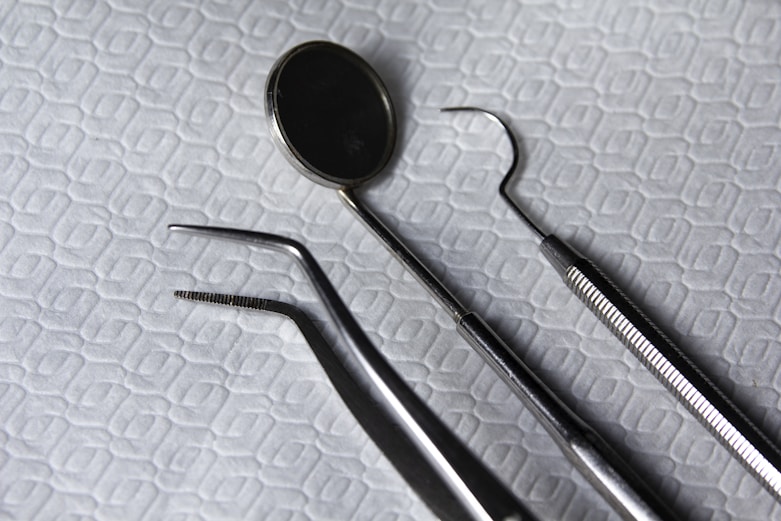 a pair of dental instruments sitting on top of a bed