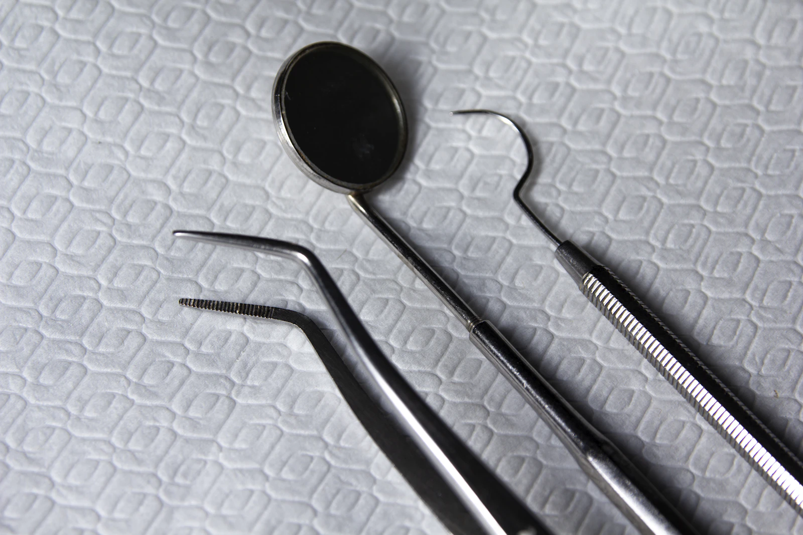 Close-up of sterilized dental instruments, mirror and probes laid out on a tray