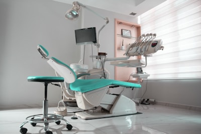 a dental room with a chair and a monitor