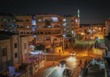 Evening shot of a neighborhood built by Al Waleed Contracting, lights glowing warmly.