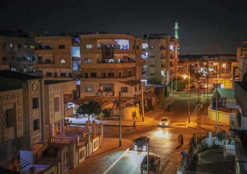 Evening shot of a neighborhood built by Al Waleed Contracting, lights glowing warmly.