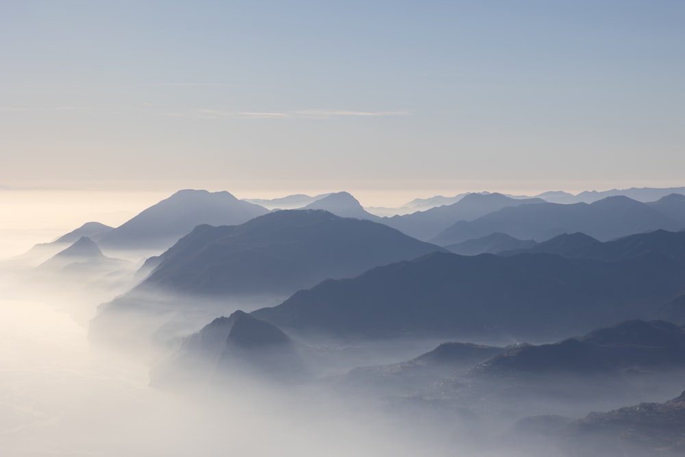 a view of a mountain range covered in fog